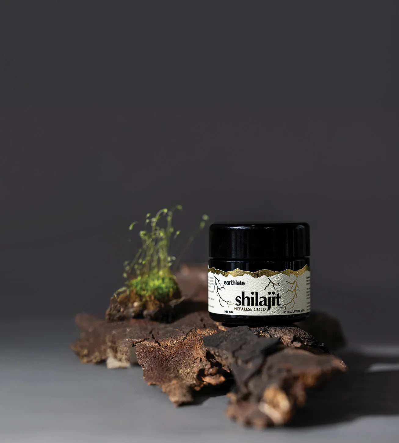 Jar of shilajit on a dark background with natural elements
