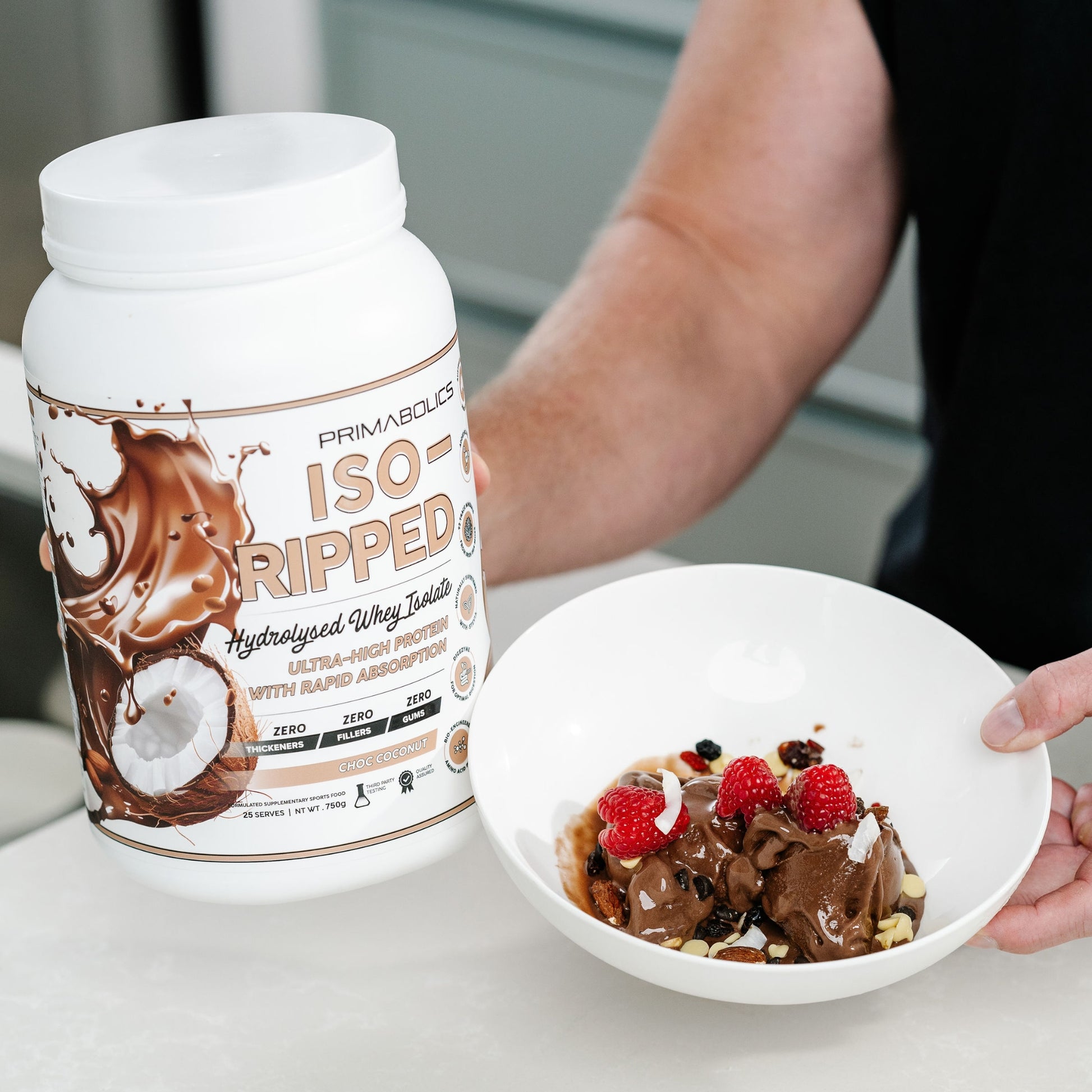 Primabolics ISO Ripped protein powder container next to a bowl of dessert with berries