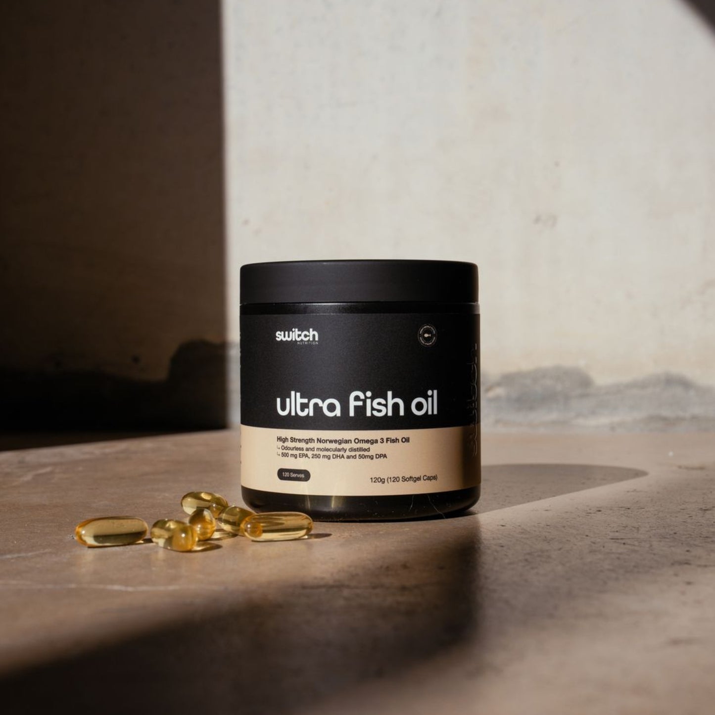 Container of ultra fish oil with capsules on a concrete surface